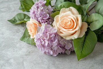 Wall Mural - Peach roses and lavender hydrangeas arranged on a grey surface.