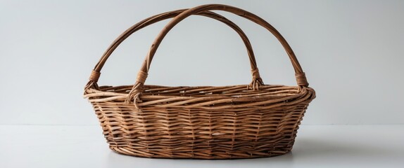 Poster - woven wicker basket with two handles on a plain white background showcasing natural materials and cr