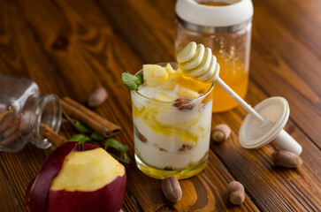 Wall Mural - sweet homemade yogurt in a glass with apples, nuts and honey