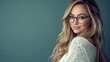 © Velar - A beautiful and pretty model, a young European business woman with curly blonde hair and glasses, looks at the camera for a close-up indoor portrait