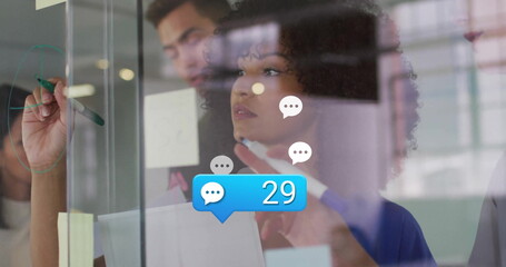 Poster - Image of media icons over diverse colleagues taking notes in office
