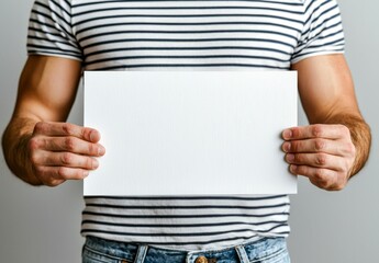 Poster - closeup of a man holding a blank poster set against a light grey background