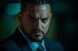 © ChaoticMind - Intense expression of a man in a dark suit with focused eyes in a dimly lit environment at night