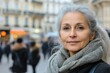 © ChaoticMind - Elderly woman with silver hair in a bustling city street during the daytime, showcasing calmness and elegance