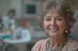 © Thanakorn - mature woman with warm smile, sitting in dental office, looking happy and content. Her hair is styled in soft waves, and she wears stylish necklace