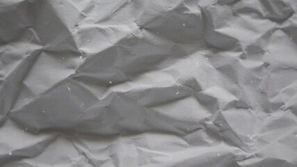 White crumpled wrinkled sheet of paper background texture. Stop motion animation. Seamless looping.