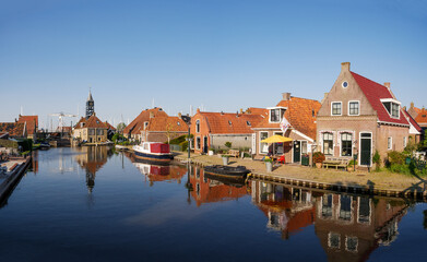 Wall Mural - Zijlroede canal with houses and Sylhus, lock house, in old town of Hindeloopen, Friesland, Netherlands