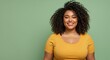 © Skyfe - Smiling Young African Woman Yellow Top Pastel Green Background - Empowerment, Self-Love, Body Positivity Marketing Campaigns