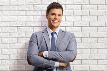 Poster - Professional young man posing on a white brick wall