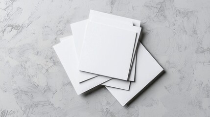 Poster - aesthetic composition of blank square paper sheets stacked on a textured surface for creative use or