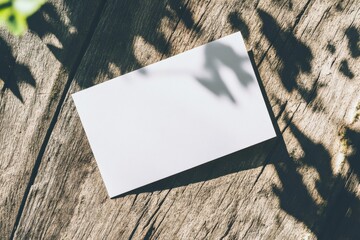 Aufkleber - Blank card resting on a weathered wooden surface illuminated by soft sunlight in a tranquil outdoor setting
