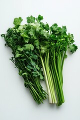 Wall Mural - Fresh greens and vegetables arranged on a clean white background