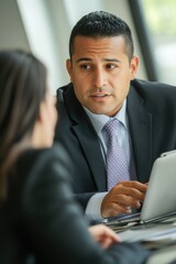 Poster - A couple sitting together at a table, both focused on the laptop screen