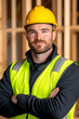 © bcendet - Construction worker smiles on-site, interior framing for a house, advertising use