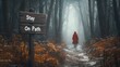 © InfinityVisuals - Atmospheric misty forest path with red hooded figure walking alone through foggy woodland, motivational sign saying Stay On Path, moody autumn scenery with fallen leaves