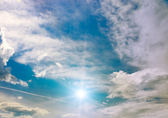 Wall Mural - cirrus clouds and sun against the blue sky.