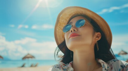 Wall Mural - Young woman enjoying a sunny beach day, wearing sunglasses and a hat, with umbrellas and ocean in the background