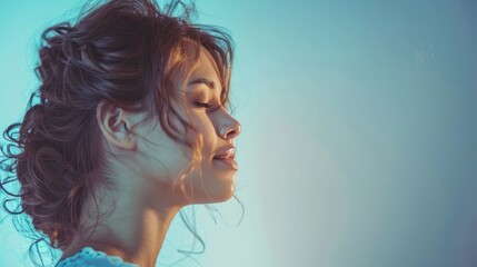 Wall Mural - Portrait of a serene young woman with curly hair, softly illuminated against a gradient background, evoking calmness