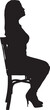© curto - vector; silhouette side view of a woman sitting on chair