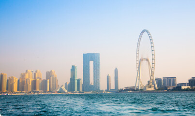 Poster - Dubai Marina beach skyscrapers, view at sunset from the boat. View include the Address Hotel and Dubai Eye 