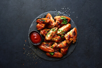 Wall Mural - Grilled spicy chicken wings with ketchup  . Top view with copy space.