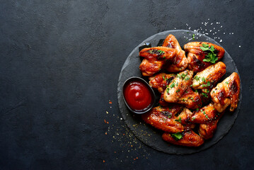 Wall Mural - Grilled spicy chicken wings with ketchup  . Top view with copy space.