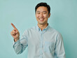 Vivid advertisement portrait photo: A man in a blue shirt pointing at the camera.