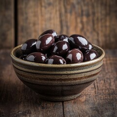 Wall Mural - Kalamata olives glistening in a ceramic bowl against a rustic wooden background