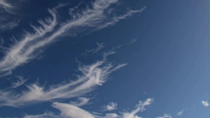 Poster - Wispy clouds against a clear blue sky, nature and weather concept