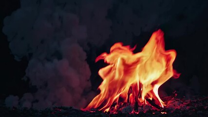 Poster - Flames against dark background, vivid fire colors. Energy and warmth concept