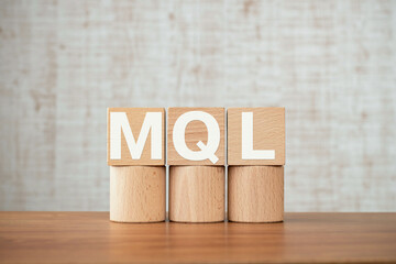 Poster - There is wood cube with the word MQL. It is an abbreviation for Marketing Qualified Lead as eye-catching image.