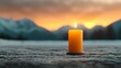 © Bos Amico - A solitary birthday candle glowing warmly against the cold serene backdrop of a snowy mountainous landscape  The candle s gentle flame illuminates the stillness and tranquility of the wintry scene