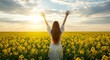 © AGUS WACHID - A young woman jumps carefree in a sunlit yellow and green meadow, arms outstretched to the blue summer sky