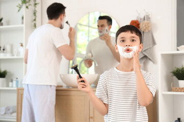 Sticker - Father and his shocked little son holding razors with shaving foam in bathroom