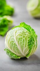 Canvas Print - Fresh cabbage on stone surface, with other vegetables blurred. Use for food blogs or healthy recipe sites