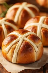 Wall Mural - Hot cross buns on paper, wooden table, foliage blurred. Easter dessert, recipe, baking, seasonal treats