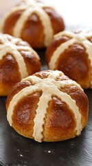 Wall Mural - Hot cross buns on slate; several in the background, ready to eat; Easter, holiday baking