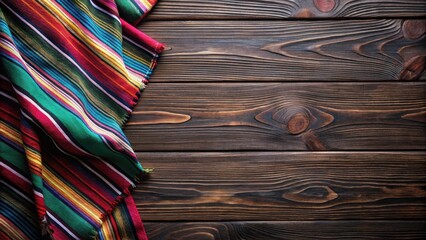 Poster - Vibrant Striped Textile Draped on Dark Wooden Surface