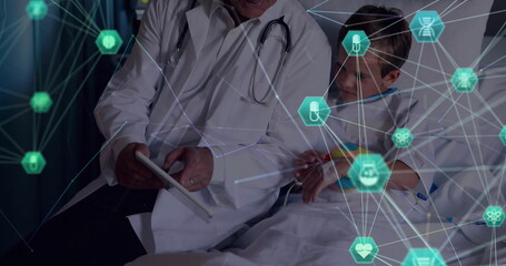 Poster - Image of globe of connections with icons over caucasian male doctor and boy patient with tablet