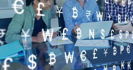 Poster - Image of currency icons over diverse colleagues using laptop in office