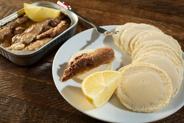 Wall Mural - A view of an appetizer of canned sardines and crackers.