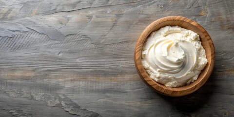 Sticker - Creamy dairy product in a wooden bowl on a rustic surface