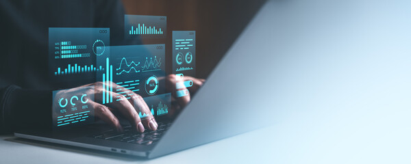 Poster - Cyber data analytics concept with hands typing on laptop and futuristic blue digital graphs on transparent screen in tech workspace.