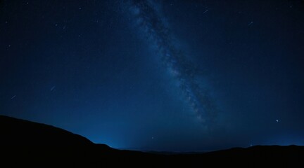 Majestic night sky with countless bright stars, Milky Way stretching across, dark mountain silhouette on the horizon, deep blue celestial view, peaceful and mysterious atmosphere.