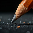 © JKLoma - Pencil Point: A close-up, macro shot of a sharpened pencil tip leaving a trail of graphite on a black surface, capturing the essence of creativity, precision, and the beginning of a new idea.
