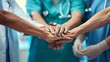 © Studicon - A group of medical professionals are holding hands in a circle