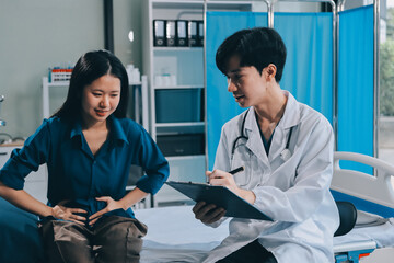 Wall Mural - doctor consulting senior old patient filling form at consultation. Professional physician wearing white coat talking to mature woman signing medical paper at appointment visit in clinic.