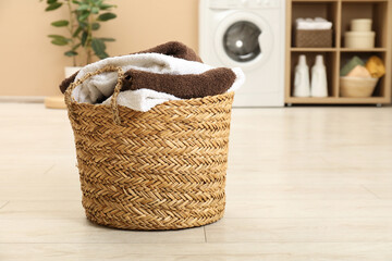 Wall Mural - Wicker basket full of laundry in bathroom