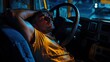 © jam - Sleepy trucker napping in cab at night; roadside assistance implied