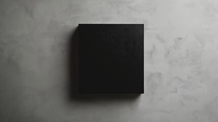 Wall Mural - A single black square placed slightly off-center on a gray background.